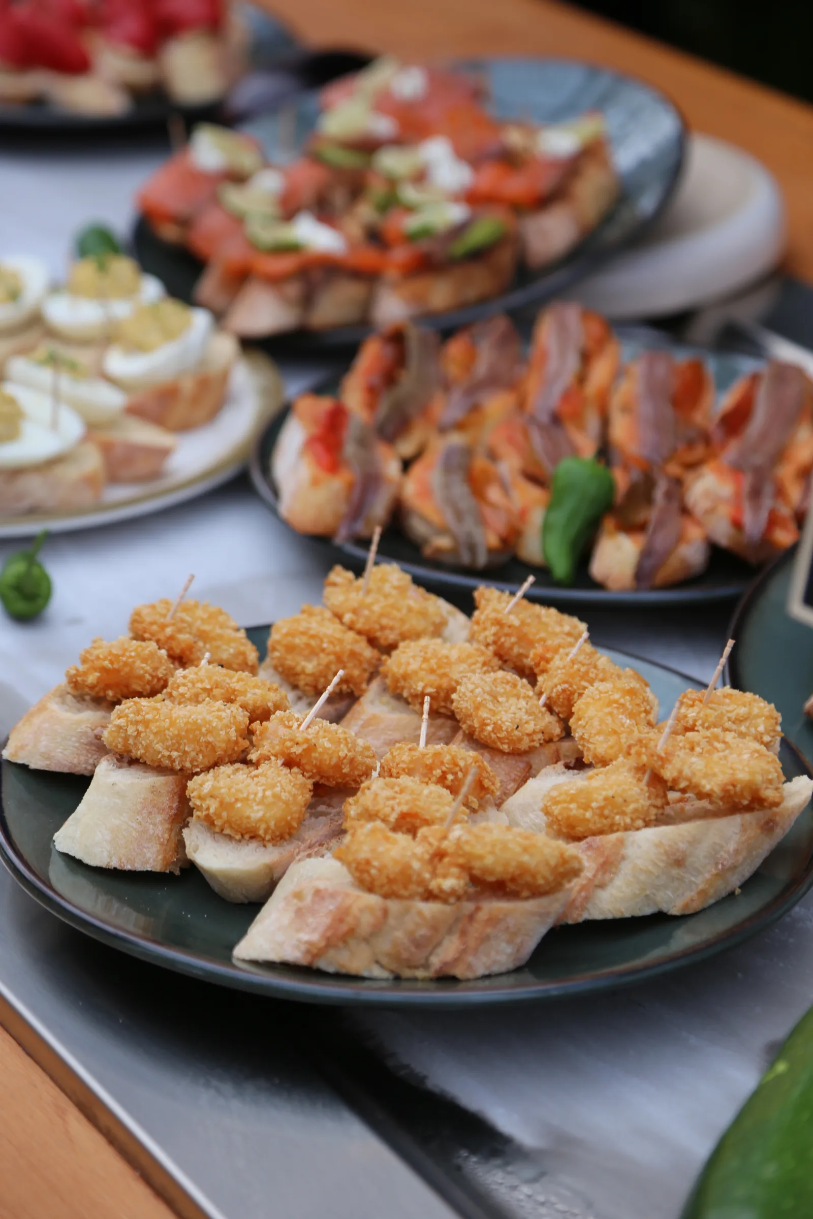 A platter of assorted appetizers including shrimp and bread.