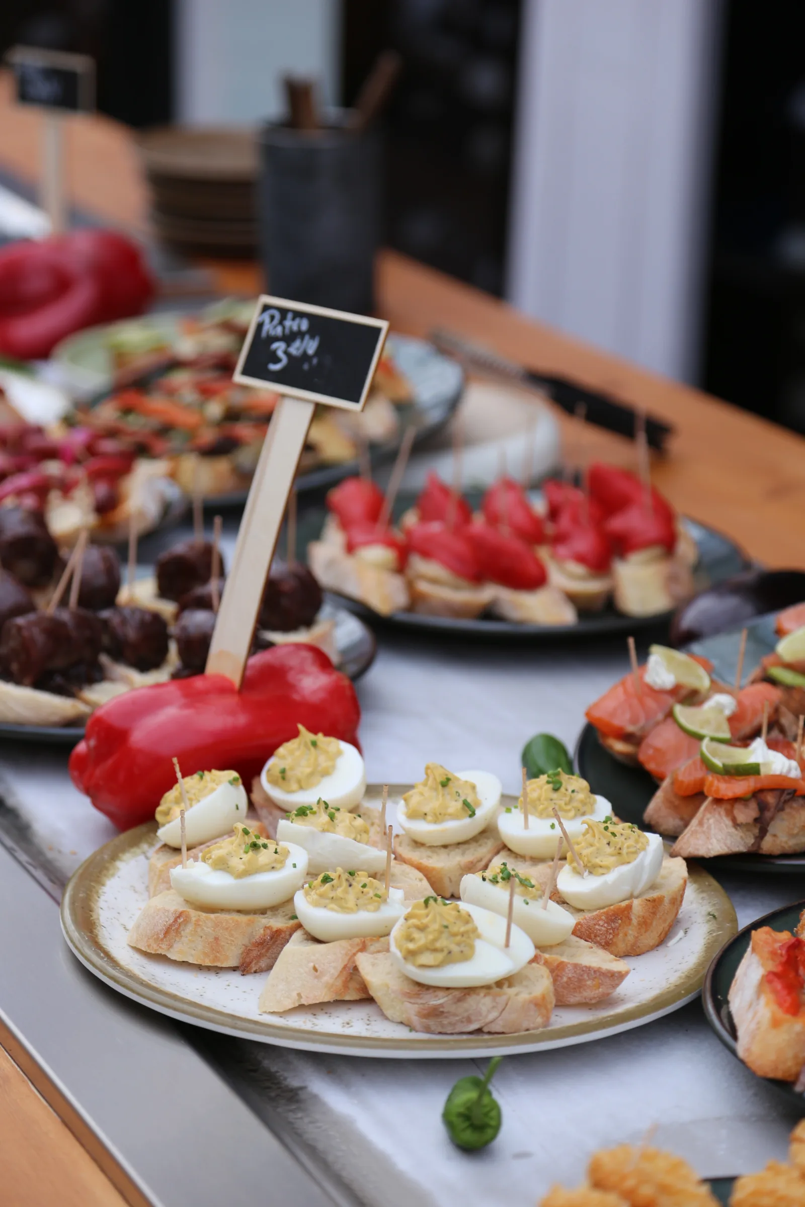 A variety of appetizers displayed on platters at a restaurant.