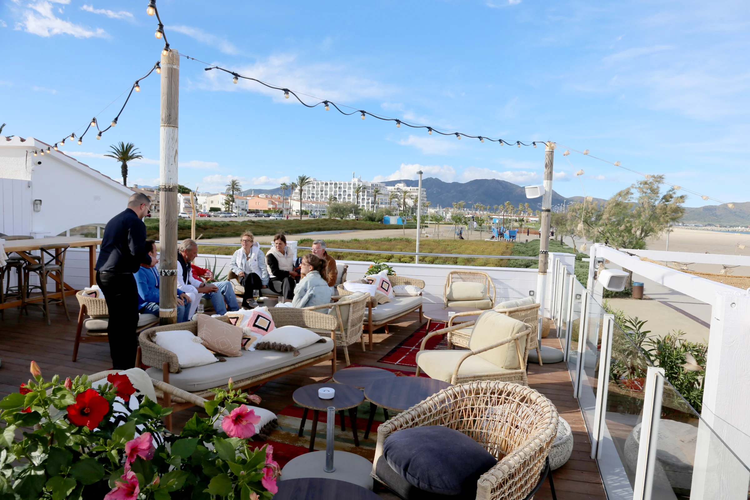 Outdoor seating area at a restaurant with guests enjoying their time.