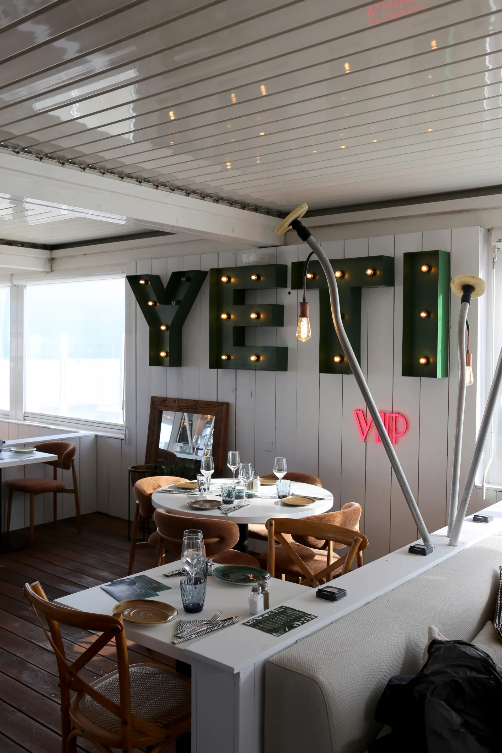 Interior of YETI restaurant with decorative lighting and tables.