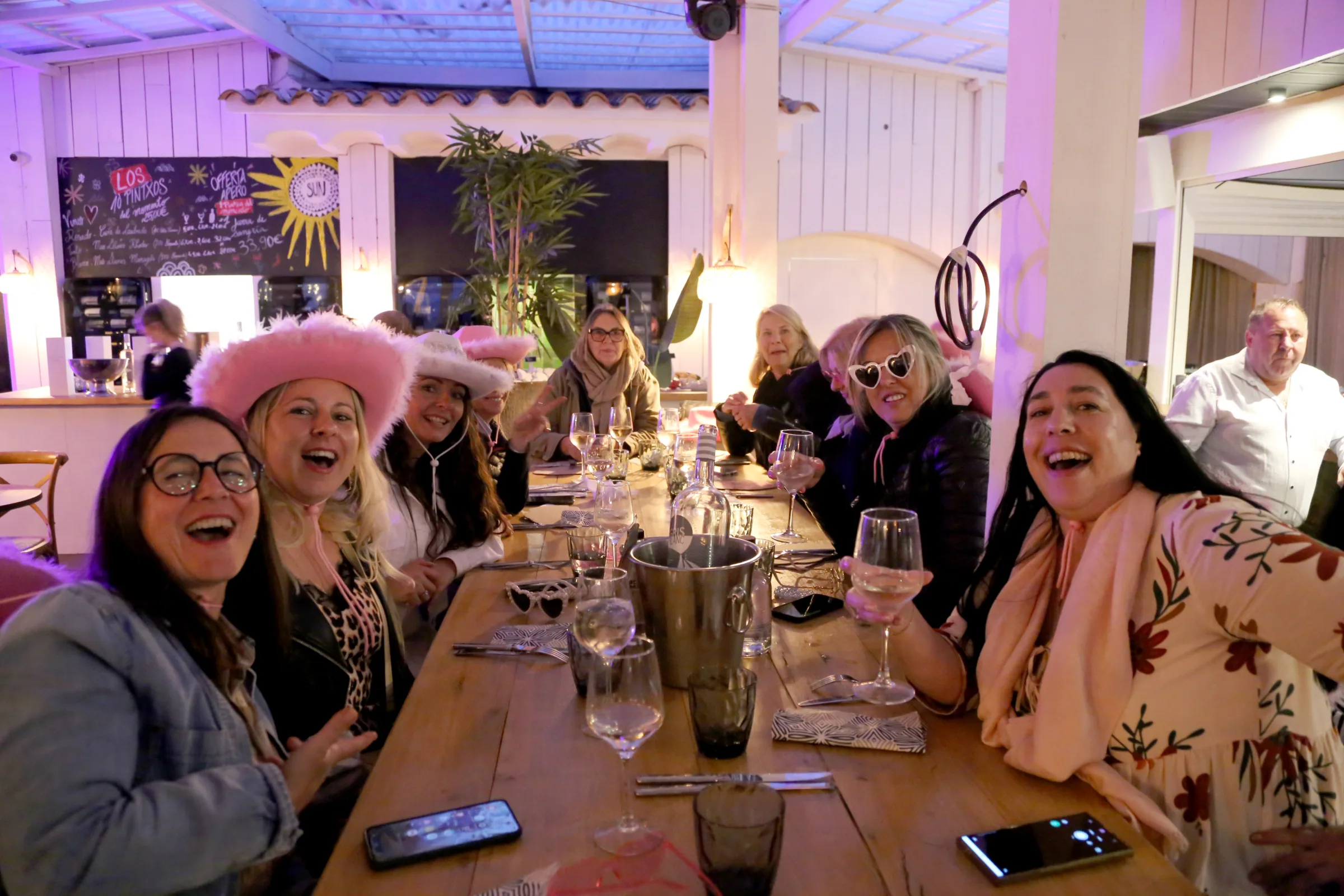Group of women enjoying a lively dinner at a restaurant.