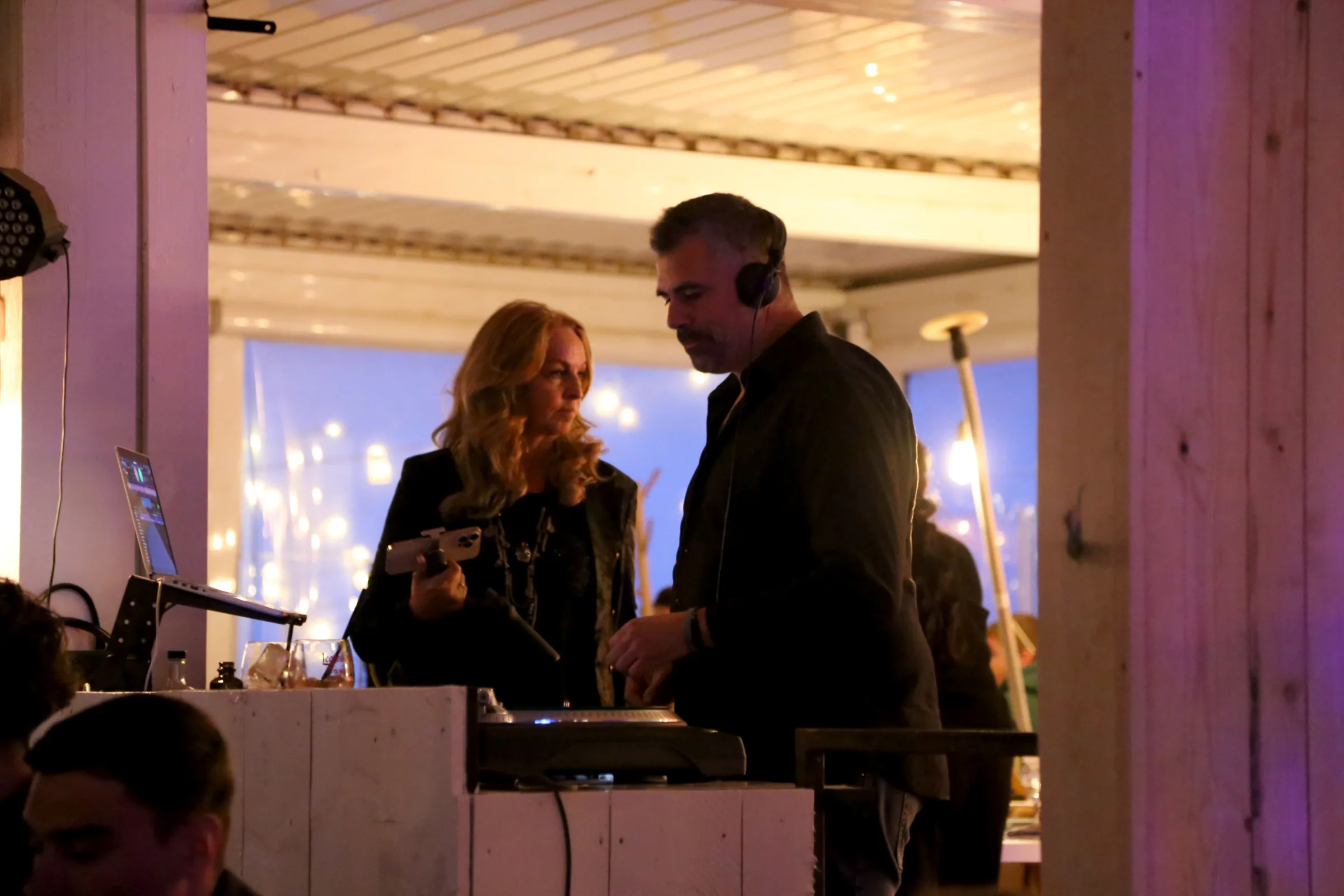 DJ and woman interacting at a restaurant event.