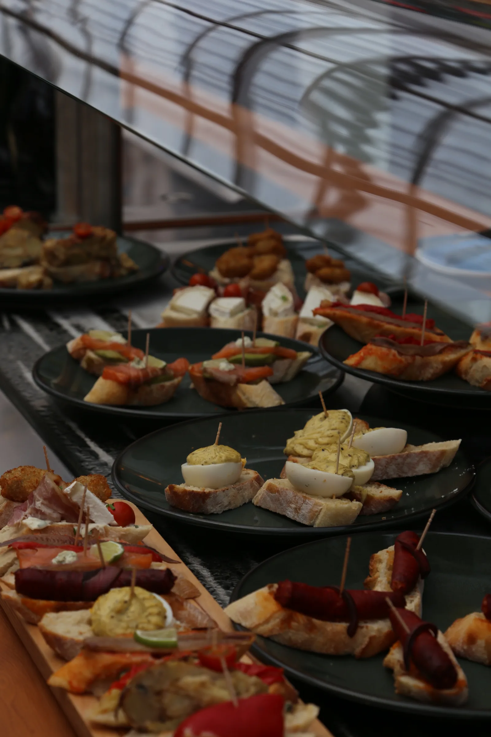 Variety of tapas served on black plates