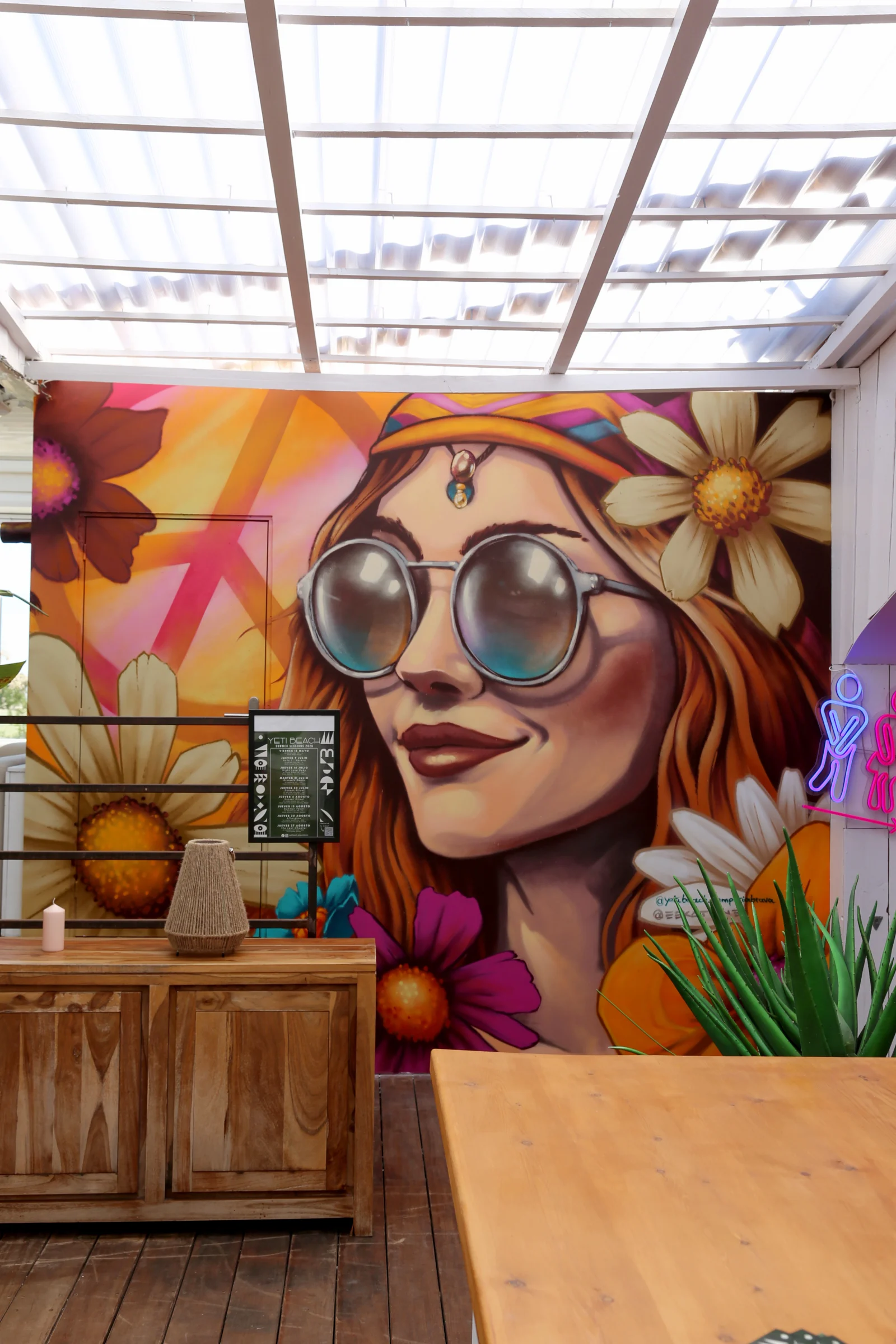 Colorful mural of a woman with sunglasses and flowers