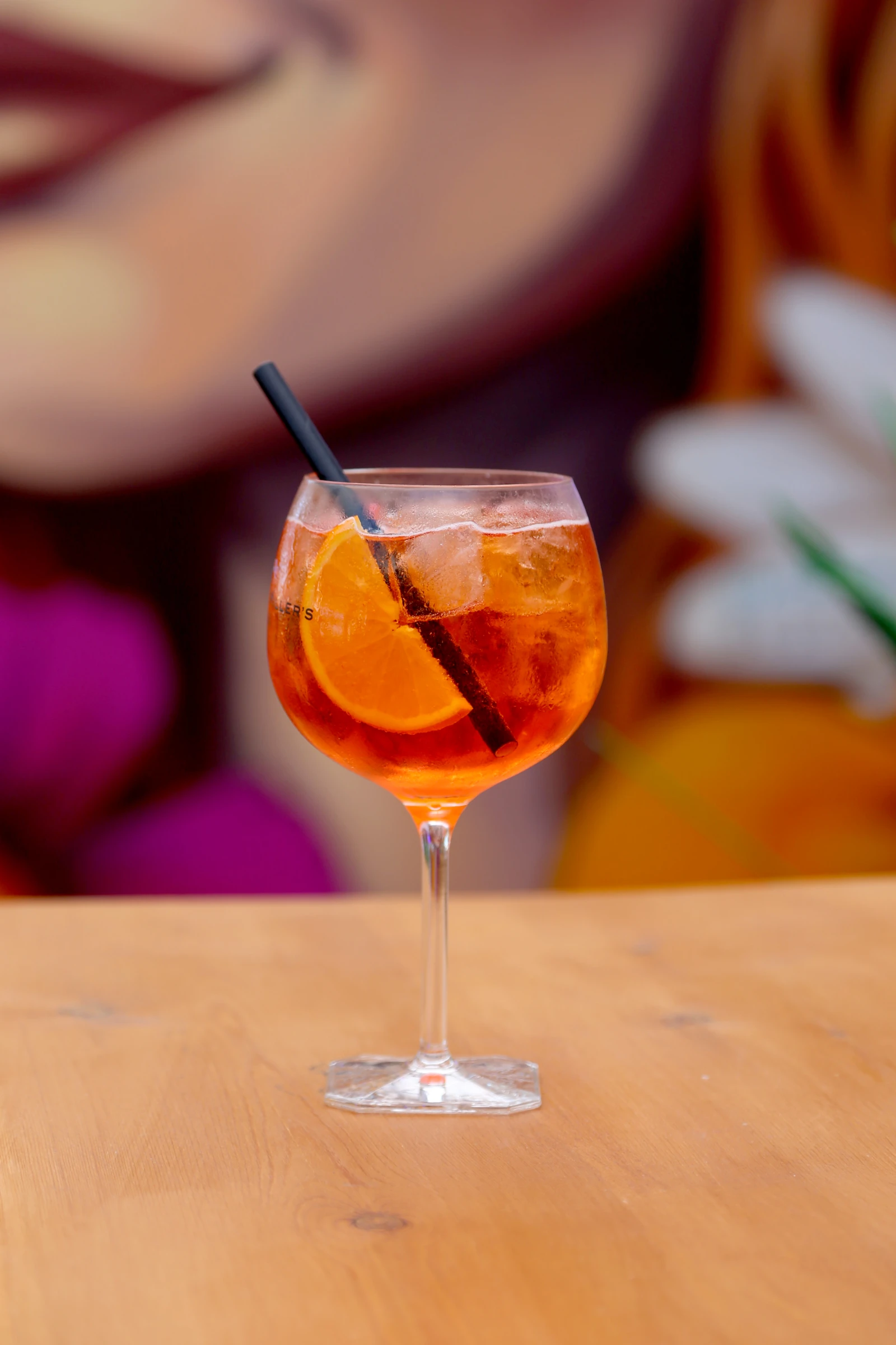 A refreshing cocktail with orange slices and ice in a glass.