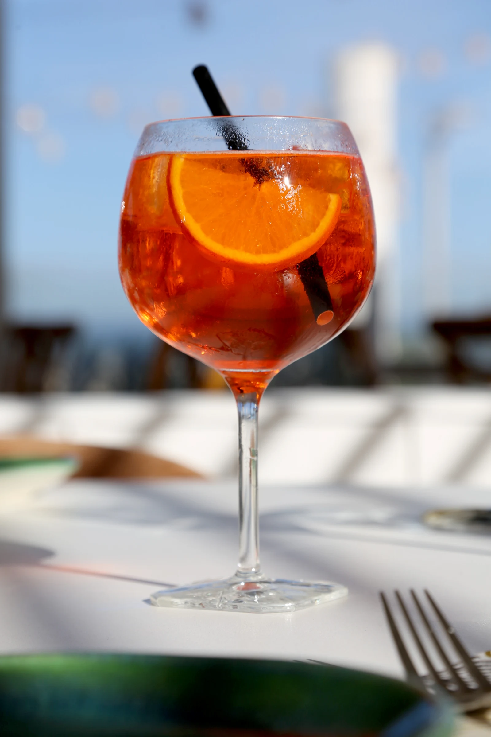 A refreshing cocktail with orange slice and straw