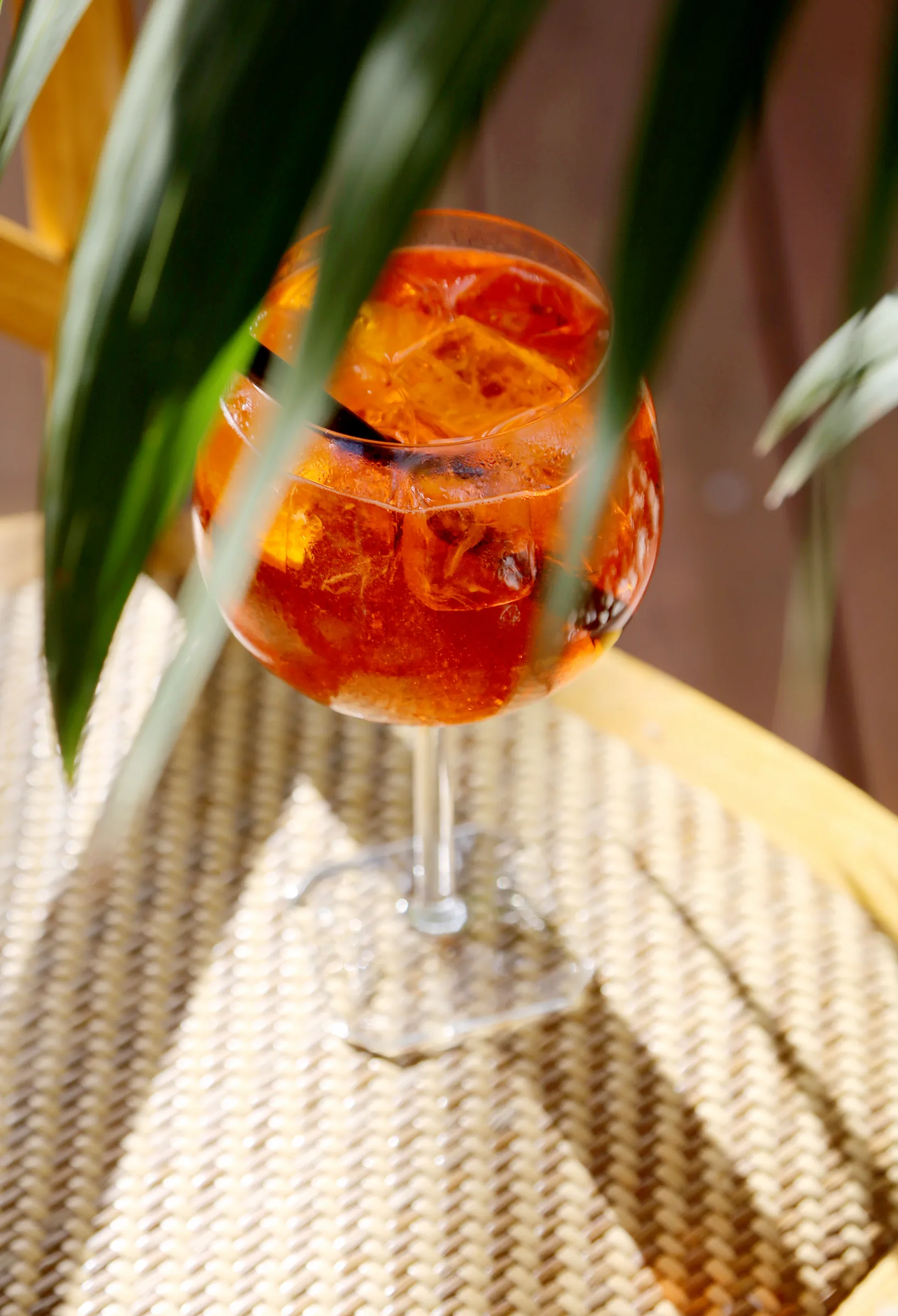 A refreshing cocktail in a glass with ice and garnishes