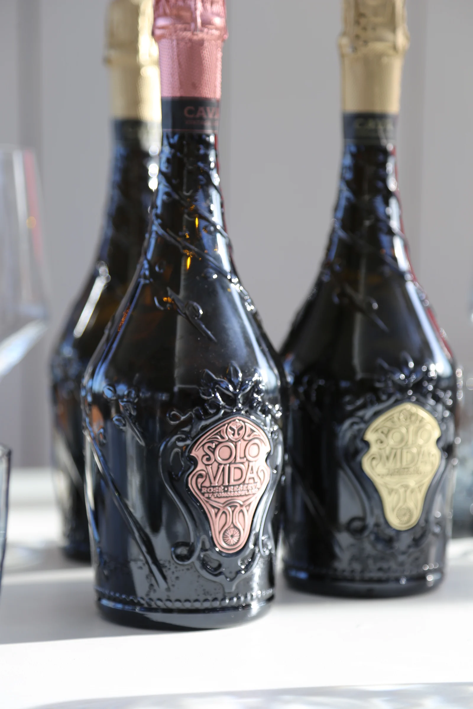 Bottles of Solo Vida sparkling wine with decorative labels