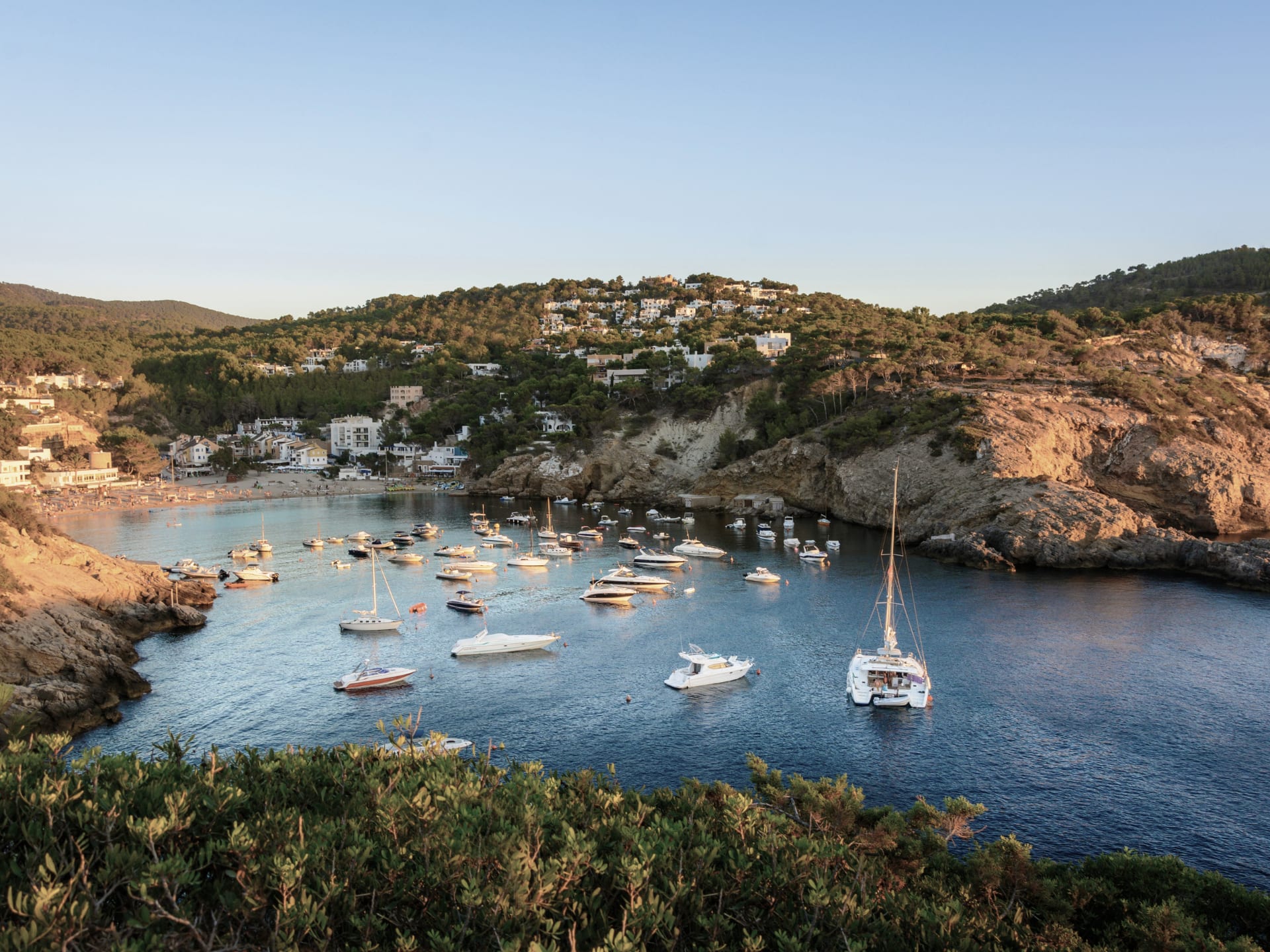 Scenic view of a marina filled with boats in a coastal bay.