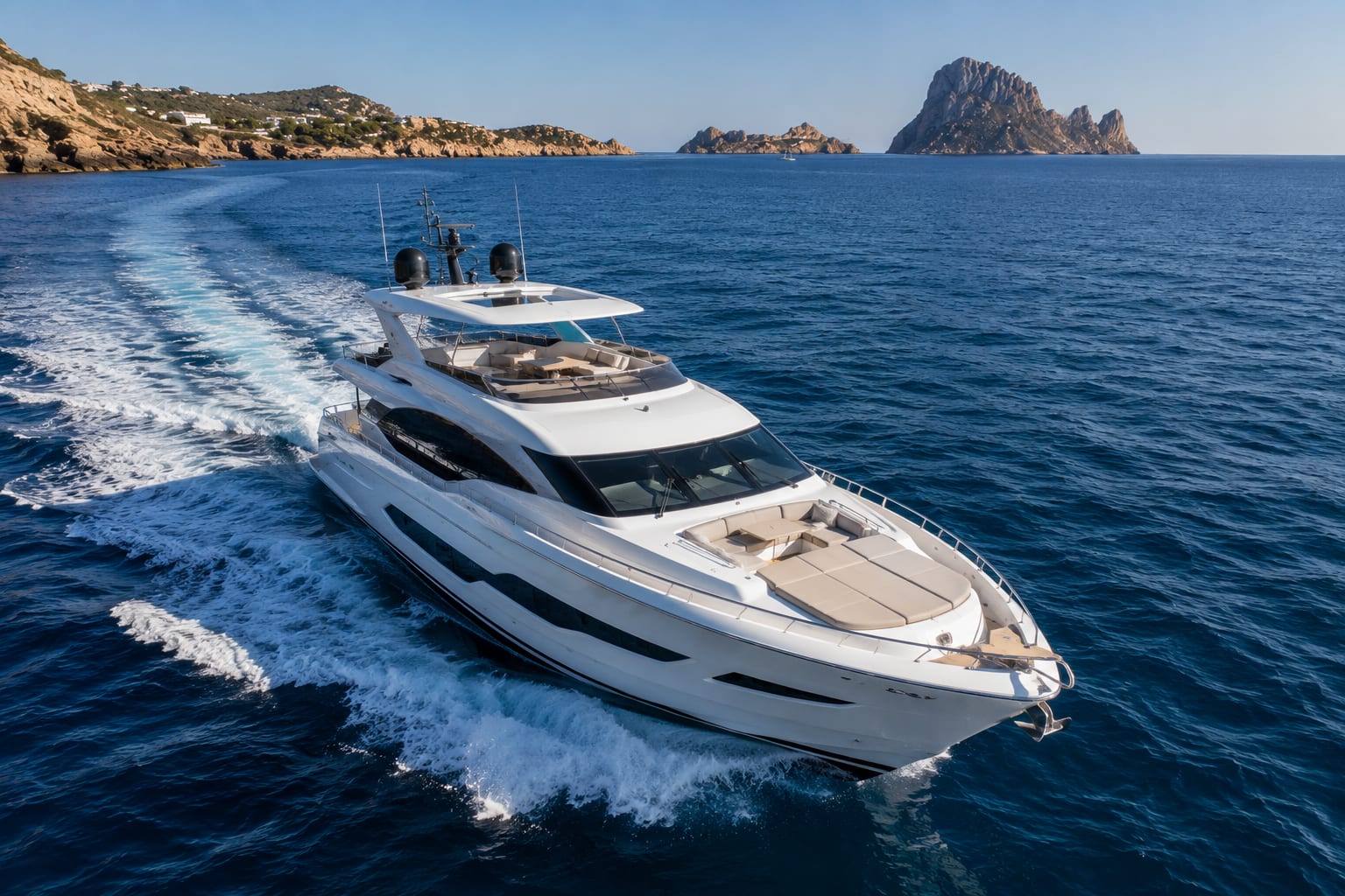 Yacht sailing on the sea with an island in the background.