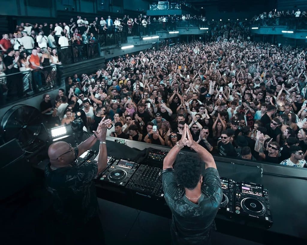 Crowd enjoying a concert with DJs at a club